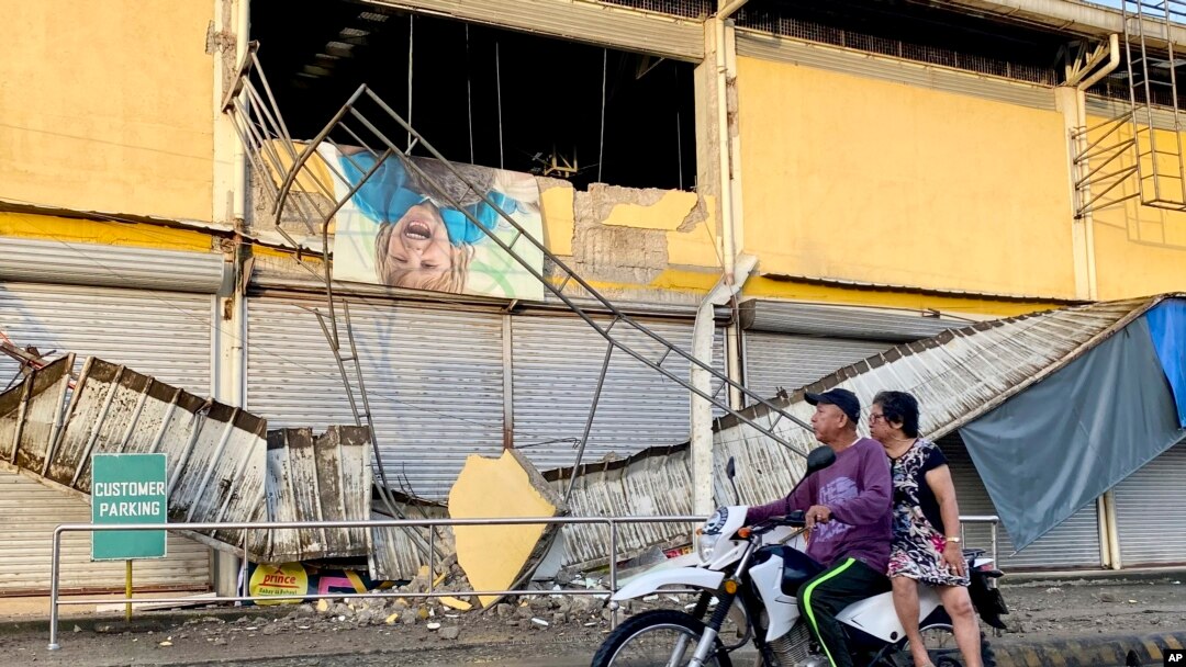 A motorcycle passes by a grocery store damaged by an earthquake in Bayugan City, southern Philippines, Dec. 3, 2023. An earthquake struck off the southern Philippine coast the night before.