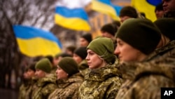 FILE - Ukrainian soldiers celebrate a Day of Unity in Odesa, Ukraine, Feb. 16, 2022. A Ukrainian court recently found blogger Wang Jixian, a software engineer from Beijing who lives in Odesa, guilty of posting videos that could harm national security.