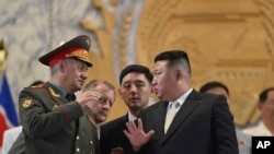 FILE- Photo by North Korean government, North Korean leader Kim Jong Un, front right, talks with Russian Defense Minister Sergei Shoigu, left, in Pyongyang, North Korea, July 27, 2023.