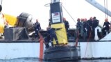 Philippine Coast Guard members place a buoy in a part of the South China Sea over which Manila claims sovereignty, in this handout image obtained May 15, 2023. (Philippine Coast Guard via Reuters). Staking its own claims, China has since responded in kind.
