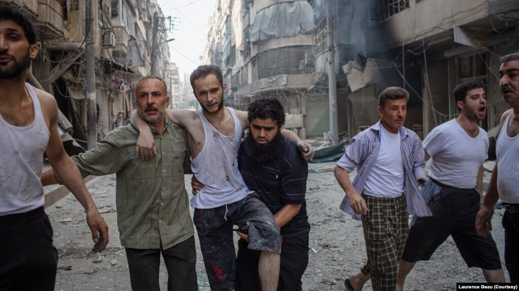 Coverage of conflict earned French photojournalist Laurence Geai a courage award from the International Media Women's Foundation. In 2014, she took this photo of an injured man fleeing a bombing in the Syrian city of Aleppo. (Laurence Geai/MYOP) 
