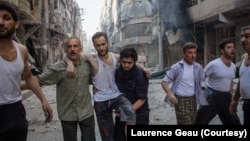 Coverage of conflict earned French photojournalist Laurence Geai a courage award from the International Media Women's Foundation. In 2014, she took this photo of an injured man fleeing a bombing in the Syrian city of Aleppo. (Laurence Geai/MYOP) 