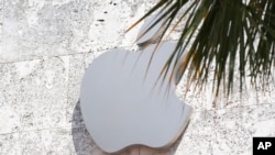 FILE - The Apple logo is displayed over their store, Sept. 19, 2023, in Miami Beach, Fla. 