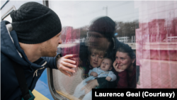 This image of a man saying goodbye to his family as they leave Odesa, Ukraine, on an evacuation train in March 2022 is part of the portfolio of work that earned Laurence Geai the IWMF courage award. (Laurence Geai/MYOP)
