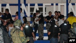 A prison official (C) who was being held hostage by inmates is embraced by a relative after being released from Machala prison, in Machala, Jan. 13, 2024. 