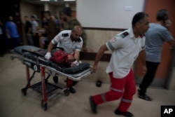 A Palestinian wounded in the Israeli bombardment of the Gaza Strip is brought to a hospital in Deir al-Balah, Nov. 14, 2023.