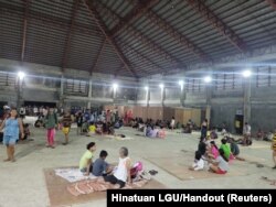 People gather at an evacuation center in the aftermath of an earthquake in Hinatuan, Philippines, Dec. 2, 2023.