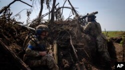 Ukrainian soldiers are positioned in a trench on the front line in Zaporizhzhia region, Ukraine, June 23, 2023.