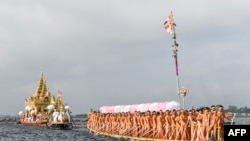 Devotees row in front of the four sacred Buddha images placed on a golden barge (L) during the festival of Phaung Daw Oo Pagoda in Inle Lake, Myanmar's Shan State. Thousands of Buddhist devotees joined a waterborne procession as one of the country's biggest festivals returned to joy and sorrow as conflict between the military and its opponents rages on. (Photo by SAI AUNG MAIN / AFP)
