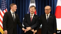 South Korea's National Security Adviser Cho Tae-yong, center, shakes hands with US national security adviser Jake Sullivan, left, and Japan's National Security Secretariat Secretary-General Takeo Akiba, Dec. 9, 2023, in Seoul, South Korea.