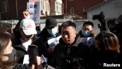 A man surnamed Fu, who lost his brother, reacts as he speaks to the media following a court hearing on compensation for those who lost their loved ones on the Malaysia Airlines flight MH370 that went missing in 2014, in Beijing, China, Nov. 27, 2023.