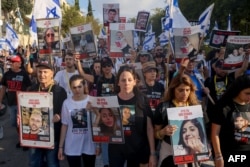 Relatives, friends and supporters of Israeli hostages held in Gaza since the October 7 attack by Hamas militants march towards Jerusalem while holding images of those taken, Nov. 16 2023.