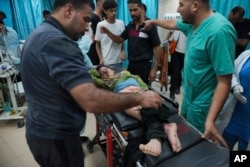 Palestinian child wounded in Israeli bombardment is brought to a hospital in Deir al Balah, south of the Gaza Strip, Nov. 2, 2023.