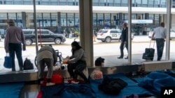 Migrants stay in a makeshift shelter at O'Hare International Airport, Sept. 20, 2023, in Chicago. 
