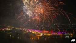 Fireworks light the sky as lamps are light up the banks of the river Saryu on the eve of the Hindu festival of Diwali, in Ayodhya, India, Nov. 11, 2023. 