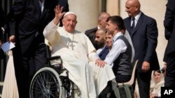 FILE - Pope Francis waves as he leaves after his weekly general audience in St. Peter's Square, at the Vatican, Aug. 28, 2024. 