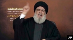 This video grab shows Hezbollah leader Sayyed Hassan Nasrallah speaking via a video link, during a rally in Beirut, Nov. 3, 2023.