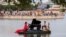 Pianist Violette Prevost performs a classical music concert over a floating platform at the Pradolongo lake, ahead of the start of summer, in the neighbouhood of Usera, Madrid, Spain June, 18, 2023. 