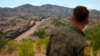 FILE - Border patrol agent Pete Bidegain looks from a hilltop on the U.S. side of the U.S.-Mexico border in Nogales, Arizona, June 25, 2024. (AP Photo/Jae C. Hong, Pool)