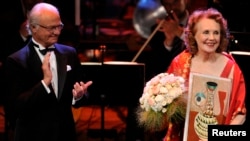 FILE: Composer Kaija Saariaho of Finland receives her award from Sweden's King Carl Gustaf at the prize-giving ceremony at Stockholm Concert Hall, Aug. 27, 2013.