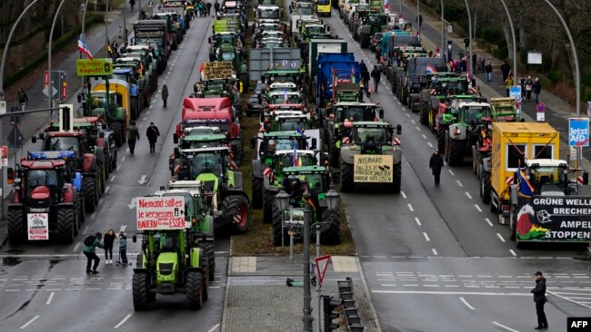 Tractors and trucks stand in a street during a protest of farmers and truck drivers, Jan. 15, 2024 in Berlin, Germany.