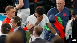 England's Marcus Rashford reacts as he leaves the pitch after a loss in a penalty shootout against Italy at the Euro 2020 soccer championship final at Wembley stadium in London, Sunday, July 11, 2021. (John Sibley/Pool Photo via AP, File)