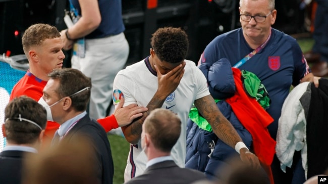 England's Marcus Rashford reacts as he leaves the pitch after a loss in a penalty shootout against Italy at the Euro 2020 soccer championship final at Wembley stadium in London, Sunday, July 11, 2021. (John Sibley/Pool Photo via AP, File)