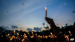 Women hold candles as they stage a protest the rape and killing of a trainee doctor at a government hospital last week, in Guwahati, India, Aug. 16, 2024.