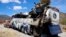 A crashed bus sits attached to a tow truck the side of the road near Villa de Tepelmeme, Oaxaca state, Mexico, Oct. 6, 2023.