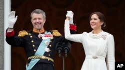 Denmark's King Frederik X and Denmark's Queen Mary wave from the balcony of Christiansborg Palace in Copenhagen, Jan. 14, 2024. 