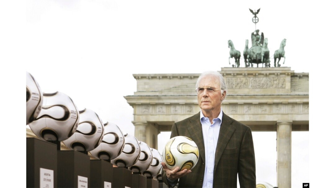 FILE - German soccer legend Franz Beckenbauer, head of Germany's organising committee for the soccer World Cup, poses with the Golden Ball for the World Cup in front of Berlin's Brandenburg Gate on April 18, 2006.
