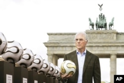FILE - German soccer legend Franz Beckenbauer, head of Germany's organising committee for the soccer World Cup, poses with the Golden Ball for the World Cup in front of Berlin's Brandenburg Gate on April 18, 2006.