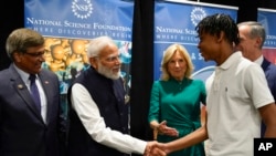 First lady Jill Biden and Indian Prime Minister Narendra Modi greet Noah Isirimah as they visit the National Science Foundation in Alexandria, Va., June, 21, 2023.
