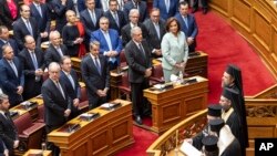 Greece's former Prime Minister and leader of New Democracy party Kyriakos Mitsotakis, third right front row, attends a swearing in ceremony at the parliament in Athens, Greece, May 28, 2023.