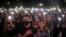 FILE - Demonstrators hold their cellphones aloft as they sing "Glory to Hong Kong" during a rally at Chater Garden in Hong Kong, on Oct. 26, 2019. 