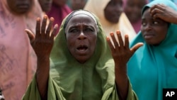 A women prays for the kidnapped LEA Primary and Secondary School students in Kuriga, Kaduna state, Nigeria, March 9, 2024.