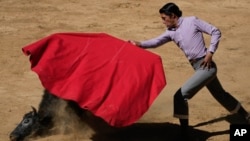 Mexican bullfighter Sergio Flores demonstrates his capework during a bullfighting workshop, in Aculco, Mexico, Jan. 25, 2024.