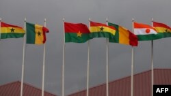 FILE - National flags of the Economic Community of West African States (ECOWAS) member states fly at the Kotoka Internatinal Airport in Accra, Ghana, on September 15, 2020. 