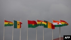 FILE - National flags of the Economic Community of West African States (ECOWAS) member states fly at the Kotoka Internatinal Airport in Accra, Ghana, on September 15, 2020. 