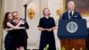 Alsu Kurmasheva's family hugs as President Joe Biden speaks about the release of Russian detainees Paul Whelan, Evan Gershkovich, Kurmasheva and Vladimir Kara-Murza at the White House, Aug. 1, 2024. At center is Paul Whelan's sister, Elizabeth Whelan.