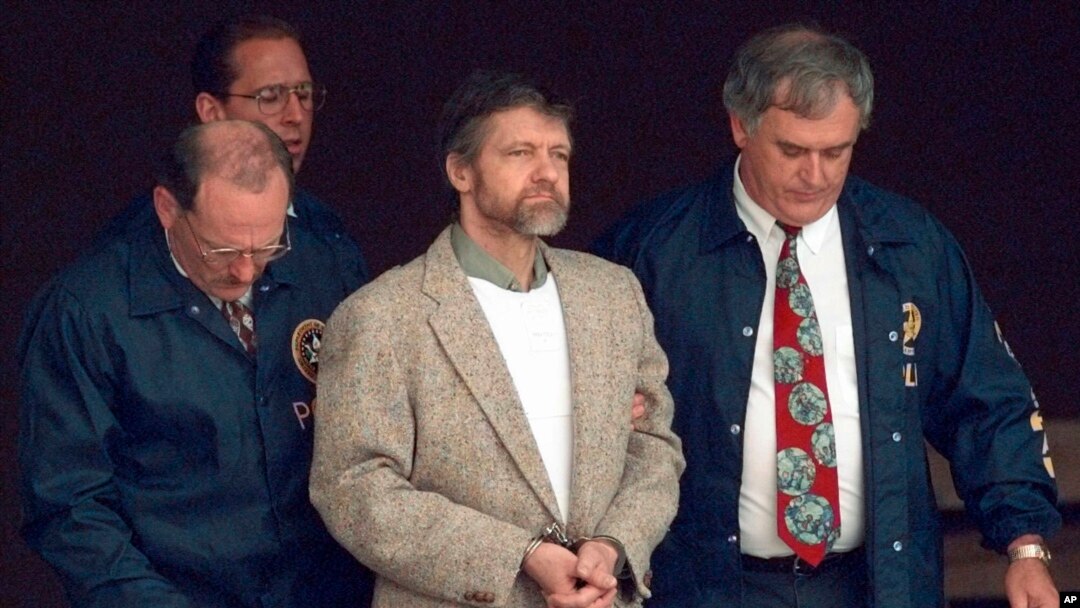 FILE - Theodore Kaczynski looks around as U.S. Marshals prepare to take him down the steps at the federal courthouse to a waiting vehicle on June 21, 1996, in Helena, Montana. 