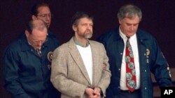 FILE - Theodore Kaczynski looks around as U.S. Marshals prepare to take him down the steps at the federal courthouse to a waiting vehicle on June 21, 1996, in Helena, Montana. 