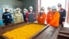 Workers at Kazakhstan's uranium producer Kazatomprom look at the yellowcake at the mining facility in the southern part the country on April 22, 2022. (Kazatomprom)