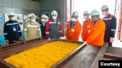 Workers at Kazakhstan's uranium producer Kazatomprom look at the yellowcake at the mining facility in the southern part the country on April 22, 2022. (Kazatomprom)