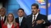 Venezuela's President Nicolas Maduro addresses the media next to his wife, Cilia Flores, after appearing before the Supreme Court of Justice in Caracas on Aug. 9, 2024.