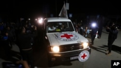 A Red Cross convoy carrying Israeli hostages heads to Egypt from the Gaza Strip in Rafah during a temporary cease-fire between Israel and Hamas, Nov. 29, 2023.