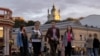 FILE - People walk in the historic district of Podil in Kyiv, Sept. 20, 2023, amid Russia war on Ukraine.