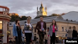 FILE - People walk in the historic district of Podil in Kyiv, Sept. 20, 2023, amid Russia war on Ukraine.