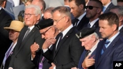German President Frank-Walter Steinmeier (L) and Polish President Andrzej Duda (3rd R) participate in commemorations to the Warsaw Uprising on the eve of the 80th anniversary in Warsaw, Poland, July 31, 2024. 