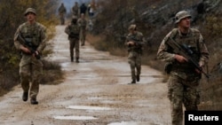 British troops, part of NATO's reinforcements, patrol the Kosovo-Serbia border in Jarinje, Kosovo, Nov. 24, 2023. 